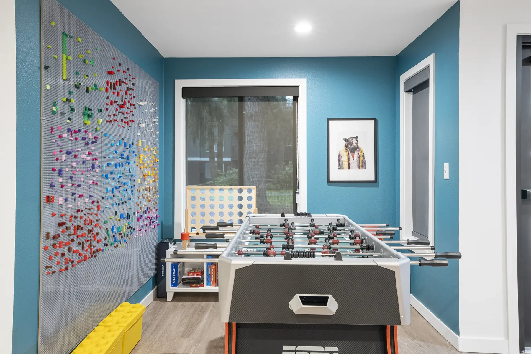 Clubhouse game room with foosball table and board games