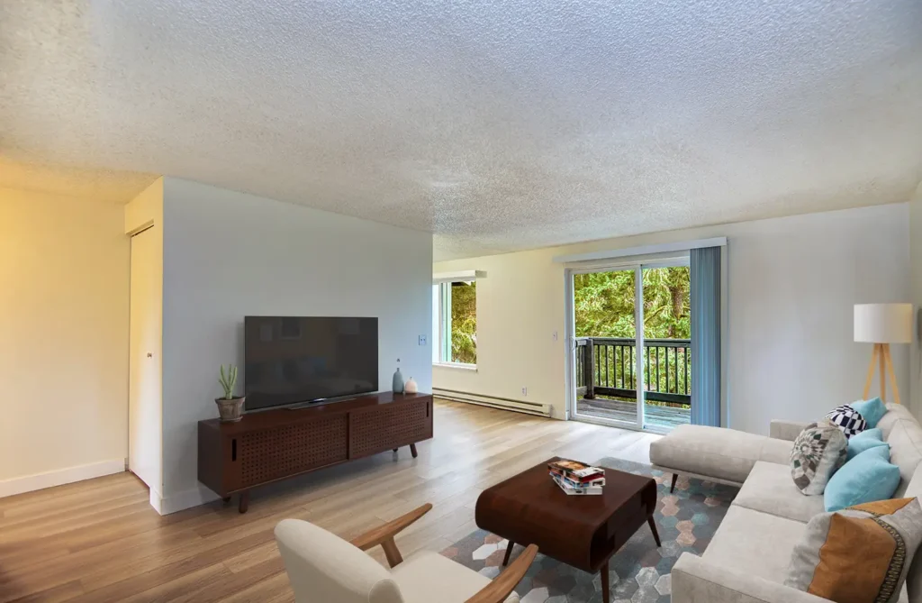 Living room with access to patio at The Woodmark apartments for rent in Tacoma, WA